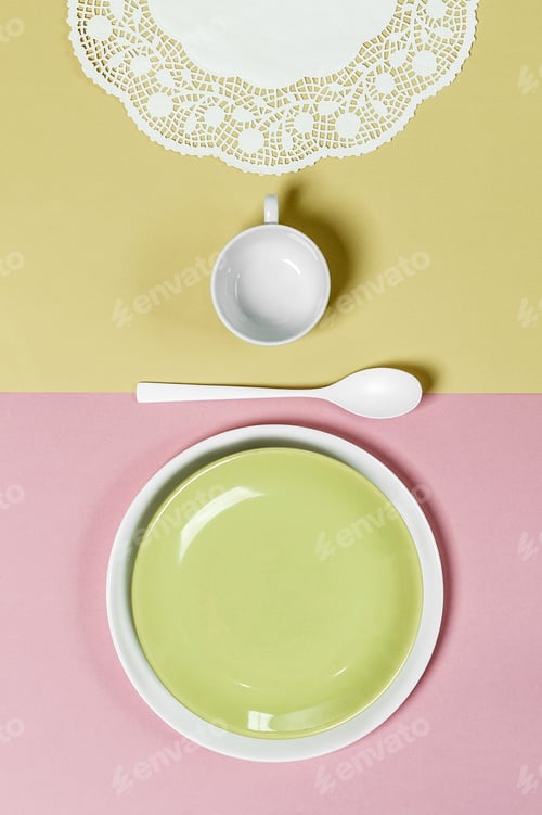 Preview: Table setting on a light pink-green background: light green plat