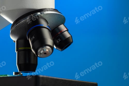 Preview: Close up photo of a microscope lenses examining glass sample