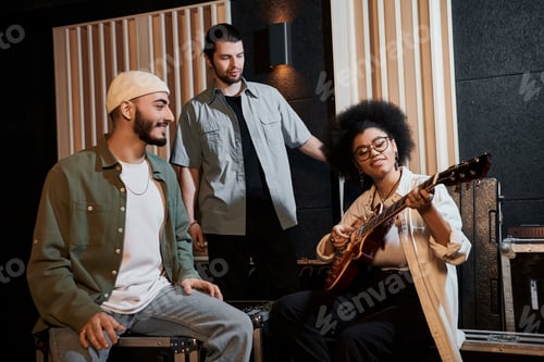 Preview: Harmonious creations: three musicians recording with guitar