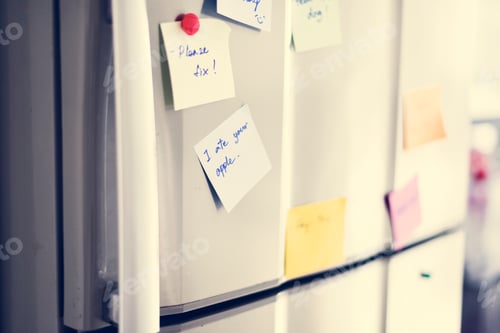 Preview: Closeup of reminder paper note on fridge door