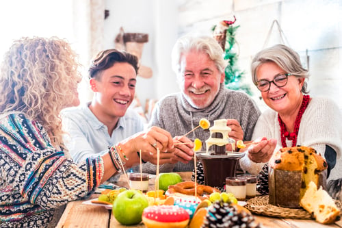 Preview: Cheerful family with mixed generations enjoy together the christmas winter eve lunch