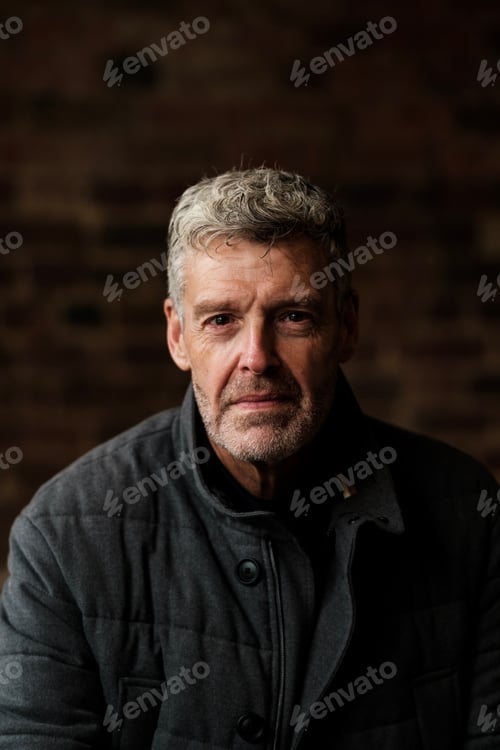 Preview: Portrait of confident senior man with grey hair and beard wearing jacket