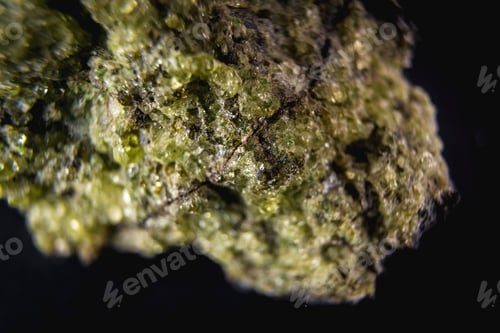 Preview: Stone with a very beautiful green mineral with a black background. Macro photography