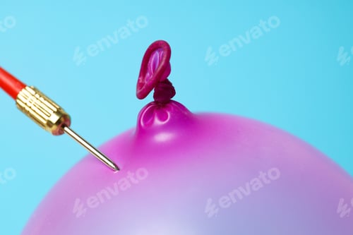 Preview: Balloon and dart on blue background, close up