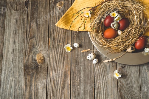 Preview: Easter eggs in a nest on a metal plate on a wooden background.