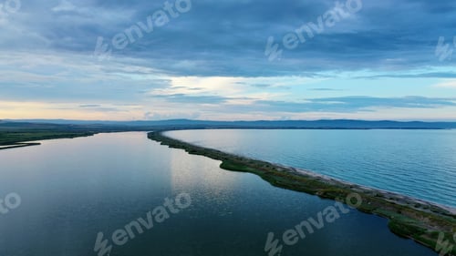 Preview: Aerial shot of the beautiful sea with a thin narrow coastline in the middle