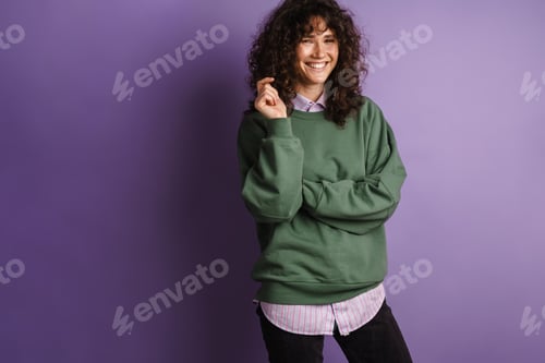 Preview: Happy beautiful curly girl smiling and looking at camera