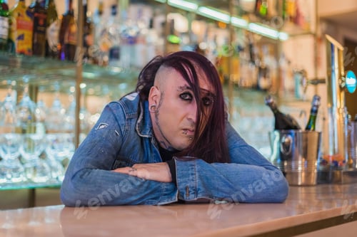 Preview: Portrait of an eccentric rocker with a denim jacket. He has long purple hair.