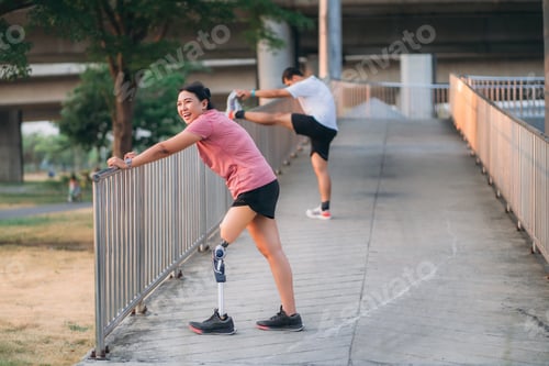 Preview: Woman wearing prosthetic equipment jogging in a park. Female walking and exercise works out outside.