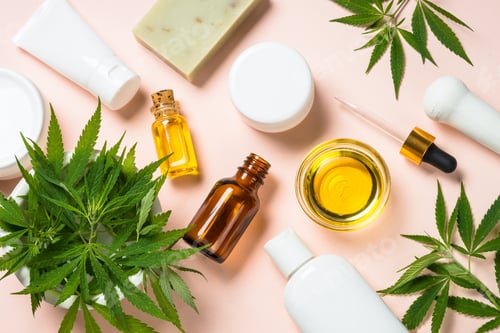 Preview: Cannabis oil, cream, soap and fresh leaves at white