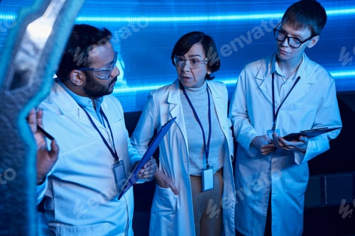 Preview: indian scientist talking near innovative equipment and colleagues in futuristic discovery center