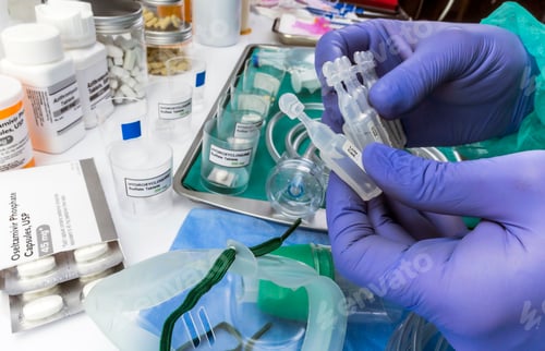 Preview: Nurse refilling medication solution nebulizer container