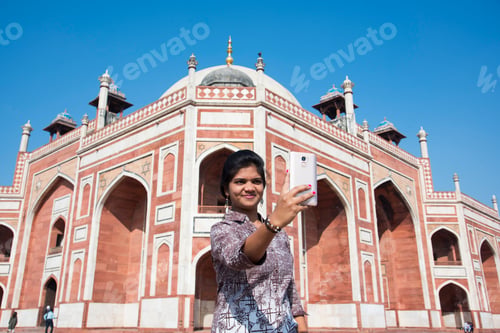 Preview: Young girl taking Photos in front of Humayun's Tomb, Delhi, India.