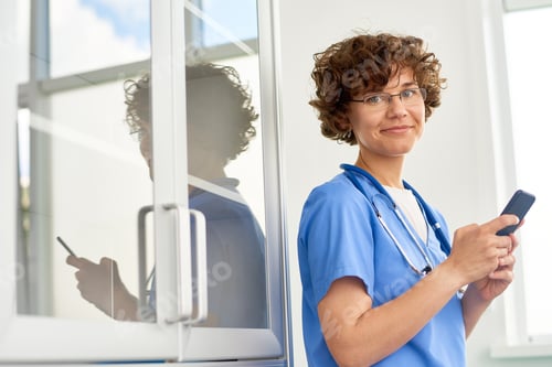 Preview: Curly Physician Using Smartphone