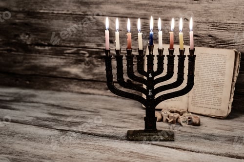 Preview: Menorah with candles for Hanukkah against defocused lights, close up