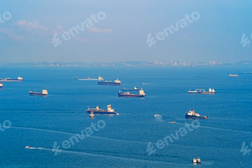 Preview: Cargo tanker ships in transportation concept. Shipping boats at Singapore harbor. Clear blue sea.