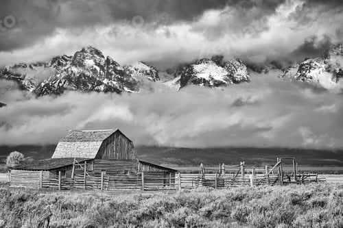 Preview: Black and white Teton mountain range with Moulton Barn in Grand