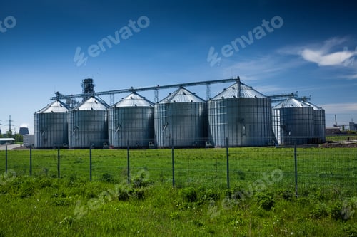 Preview: grain elevator at field against deep blue sky
