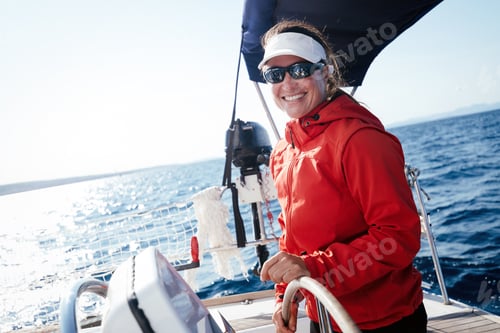 Preview: Attractive strong woman sailing with her boat