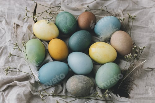 Preview: Happy Easter! Easter eggs on rustic linen napkin with tender flowers flat lay. Rustic still life