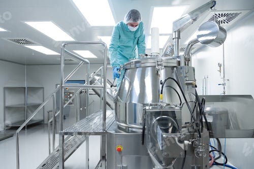 Preview: Pharmaceutical factory man worker in protective clothing operate production line in sterile working