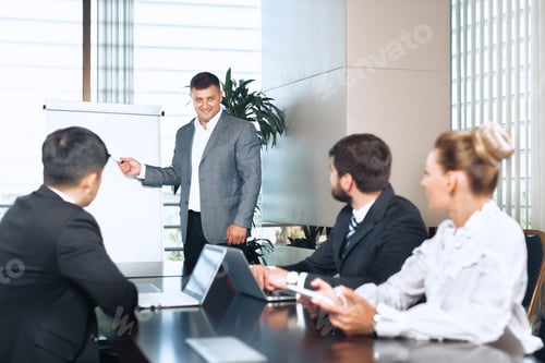 Preview: Business meeting showcasing a confident speaker presenting in a modern office setting