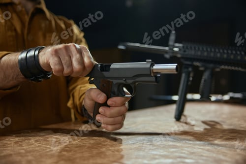 Preview: Weapon store retailer or client reloading handgun portrait with selective focus