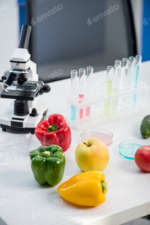 Preview: microscope, fruit, vegetables, test tubes on table in lab