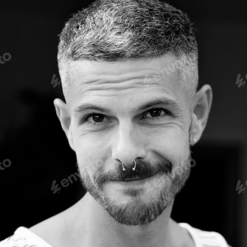 Preview: Grayscale portrait of an adult Spanish man with a septum piercing outdoors