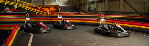Preview: three racing cars inside of indoor kart circuit, motor race vehicles, kart for speed racing, banner