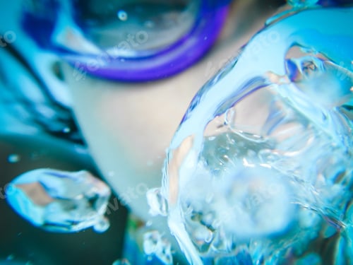 Preview: Asian girl swimming underwater exhaling air bubbles