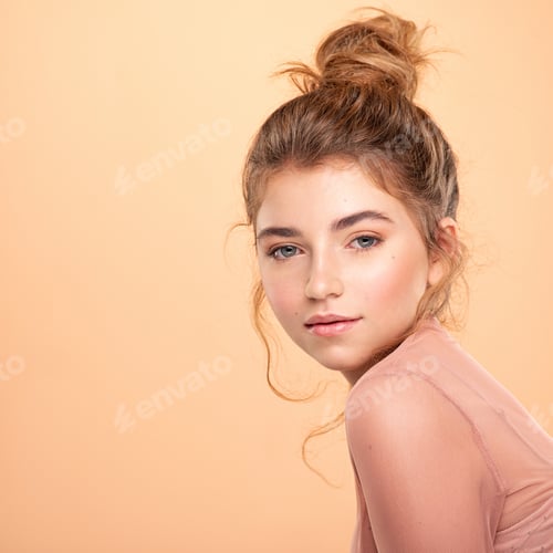 Preview: Closeup portrait of an young girl over colored background. Fashion model posing at studio.
