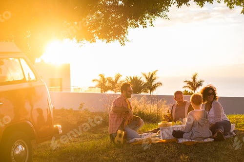Preview: Family freinds enjoy togoether lunch or picnic outdoors leisure activity sitting on a meadow