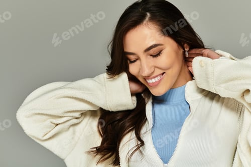 Preview: Stylish young woman smiles confidently in chic outfit, embracing modern fashion trends