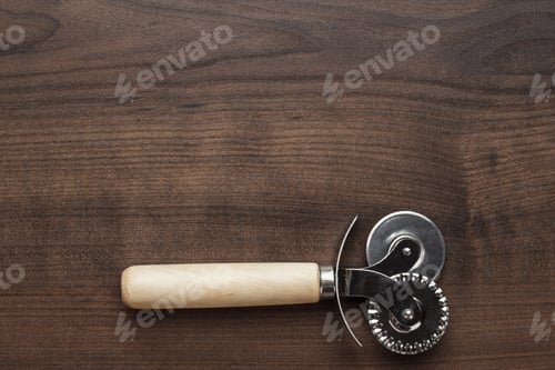 Preview: Pizza Cutter On The Wooden Table