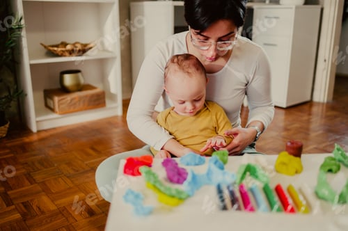 Preview: Mother and son molding a clay at home and having educational act