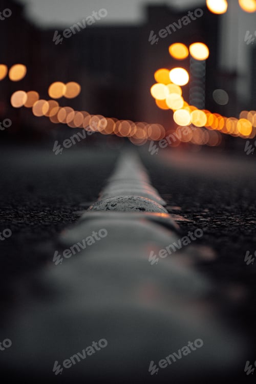 Preview: Dramatic vertical shot of an asphalt road with light bokeh