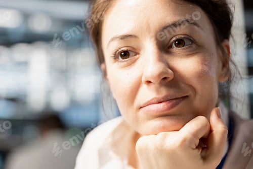 Preview: Smiling data center IT professional monitoring system performance, close up