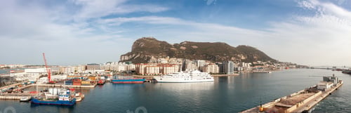 Preview: City Buildings, Port and Mountain by the Sea. Cloudy Sunny Sky. Gibraltar, United Kingdom.
