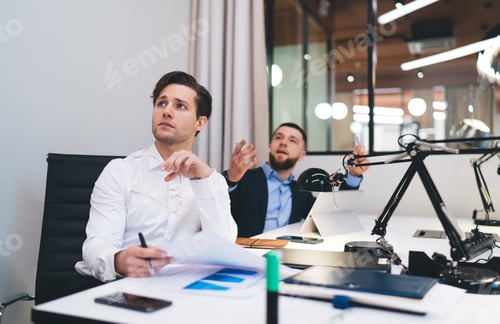 Preview: Confident businesspeople working on project together