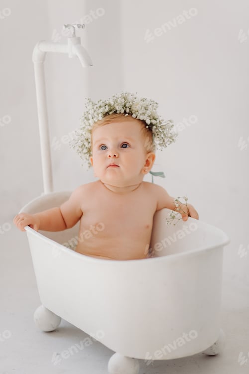 Preview: Charming Infant with Floral Crown in Bathtub