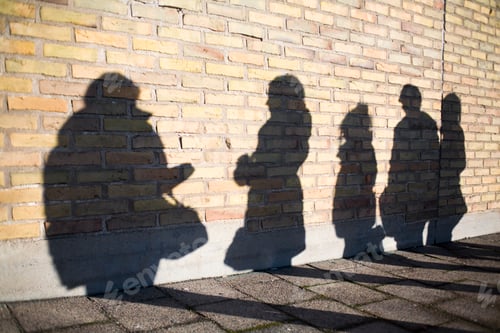 Preview: Shadow of high school students on wall outdoors