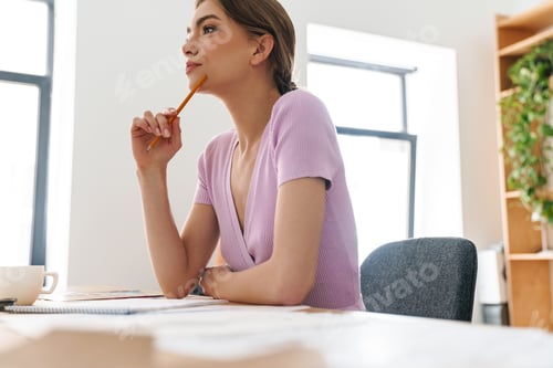 Preview: Photo of woman designer making sketches while working at table