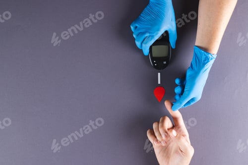 Preview: Hands of gloved doctor with glucometer taking blood sugar reading from caucasian woman, copy space