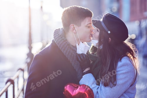 Preview: Happy couple celebrating Valentines Day in masks during covid-19 pandemic