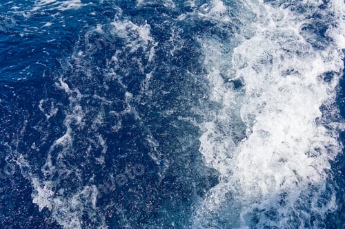 Preview: Abstract blue sea water with white waves. Blue sea texture with waves and foam. Mediterranean sea