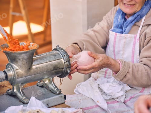 Preview: Laughing elderly woman making sausage