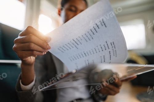 Preview: Close-up of black businesswoman going through reports.