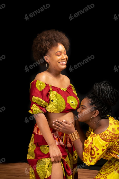 Preview: Portrait of two women against black background.