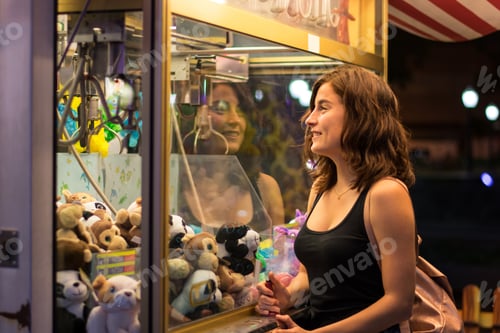 Preview: Young woman is playing a game in a fair